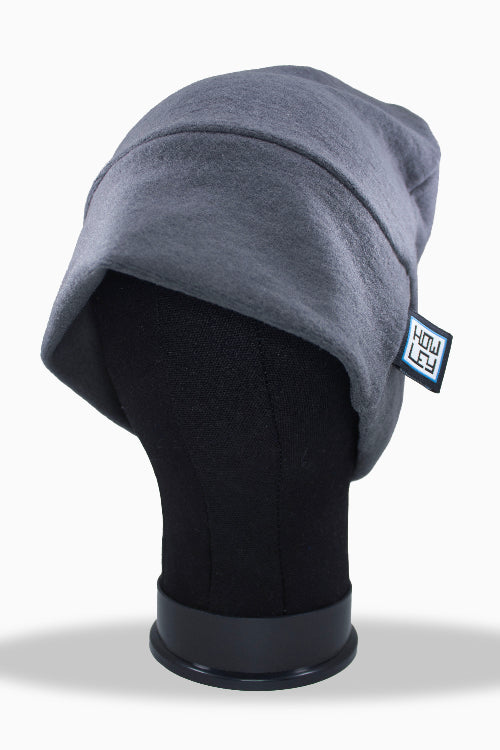 Gray beanie on a mannequin head with a visible brand label against a white background