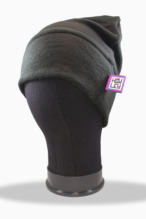 Gray merino wool beanie on a mannequin head with a visible brand tag against a white background