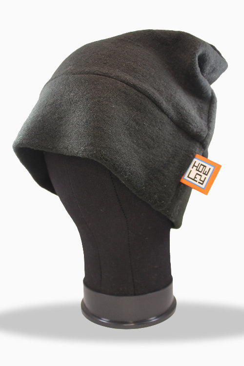 Dark gray merino beanie on a mannequin head with an orange tag against a white background