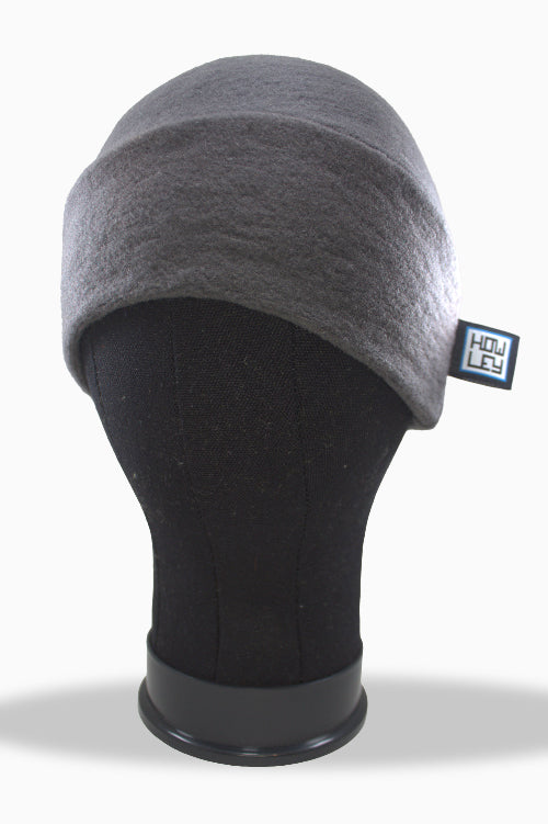 Gray winter beanie on a mannequin head with a visible brand tag against a white background
