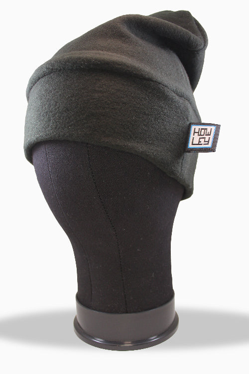 Dark gray beanie on a mannequin head with a brand logo tag.