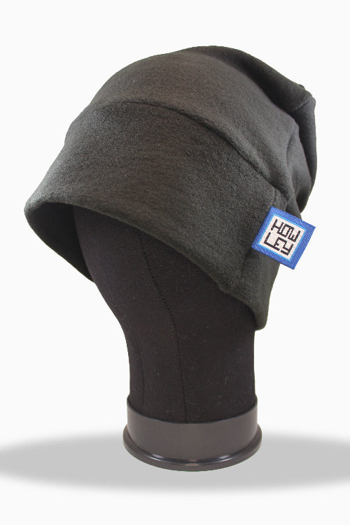 Gray merino blend beanie on a mannequin head with a visible brand logo against a white background