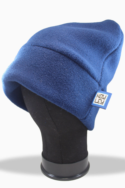 Blue fleece beanie on a mannequin head with a visible brand logo against a white background
