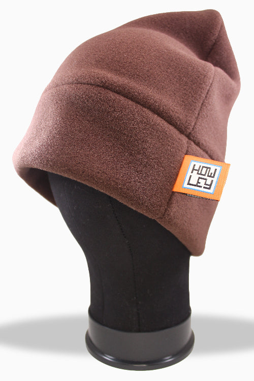 Brown polartec winter hat on a mannequin head with a visible brand label against a white background